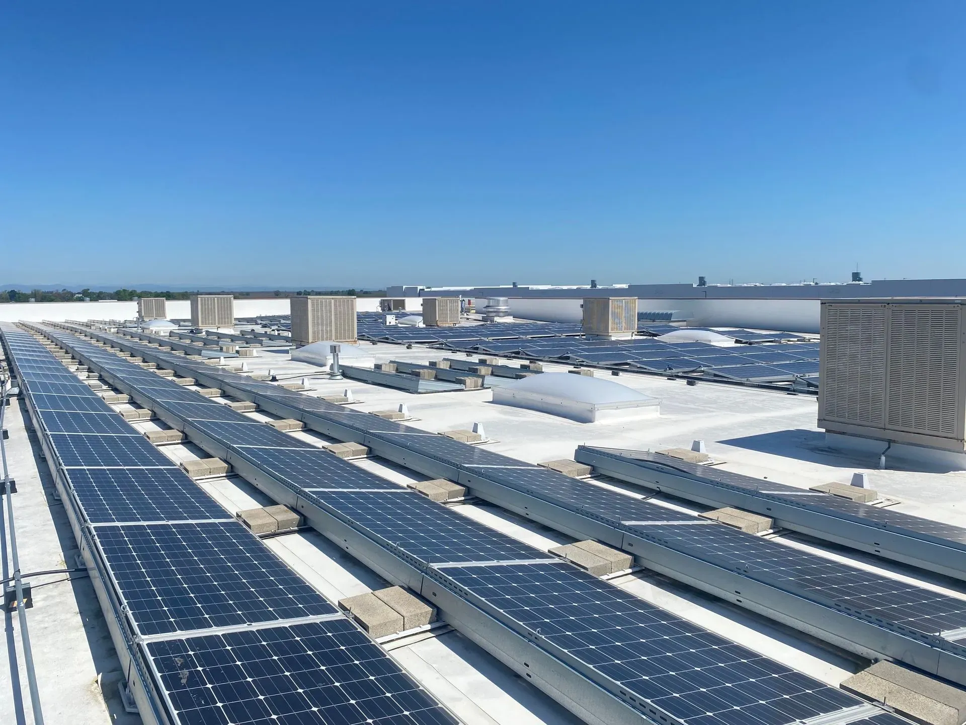 A row of solar panels on the roof of a building