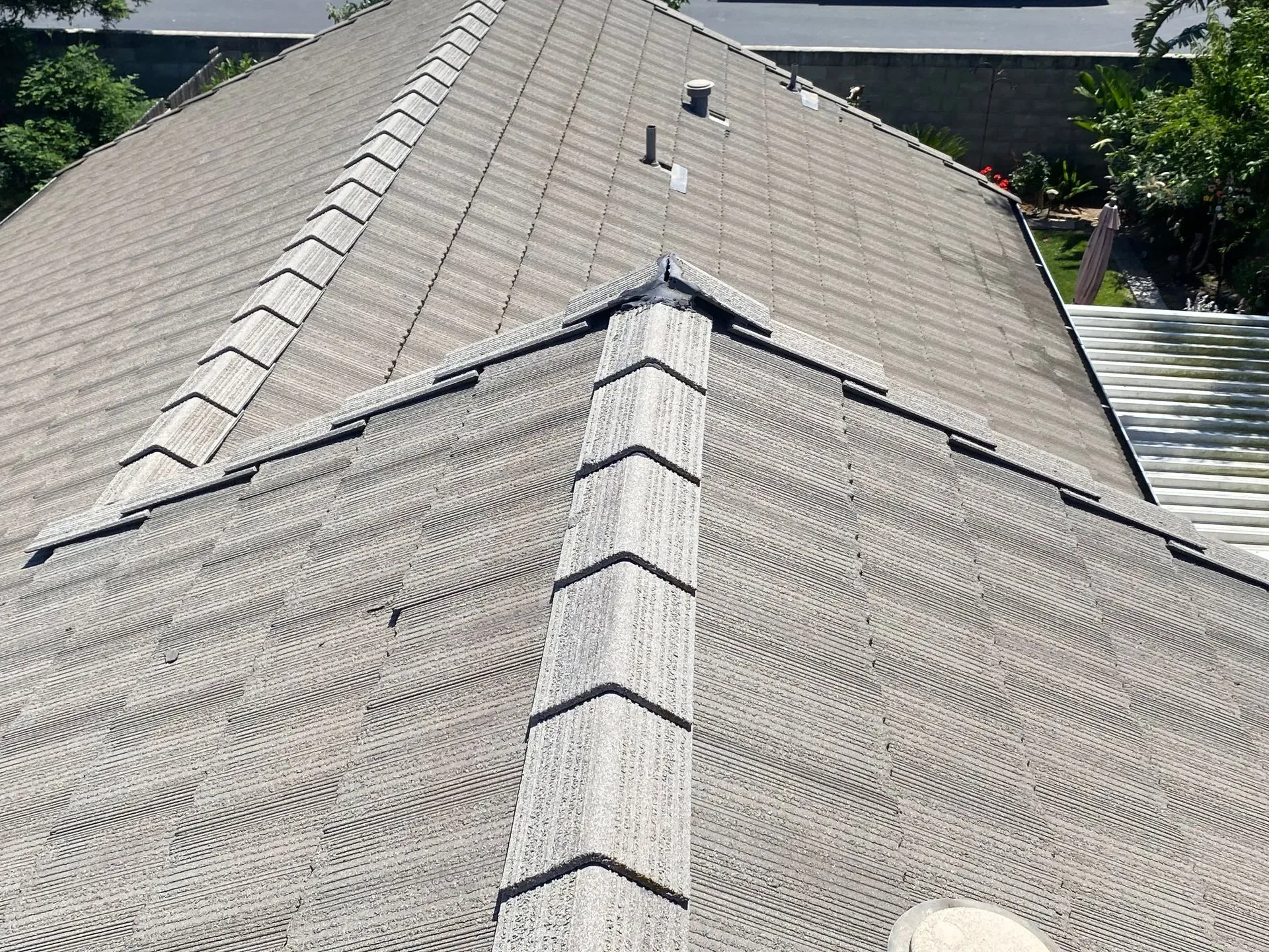 A person is standing on the roof of a house.