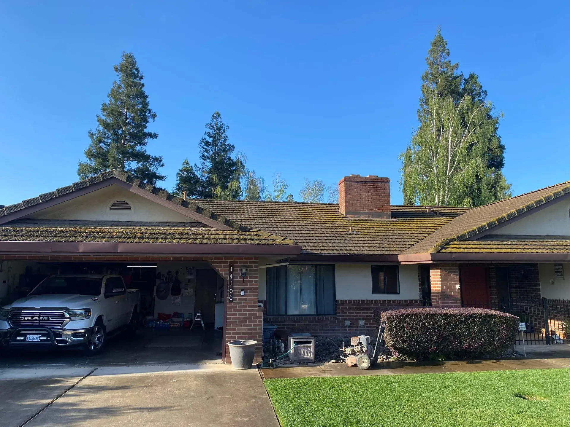 A white truck is parked in front of a house.