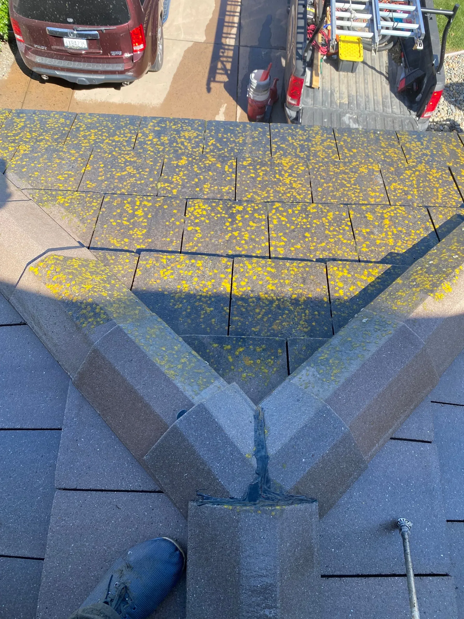 A car is parked on the side of the road next to a roof.