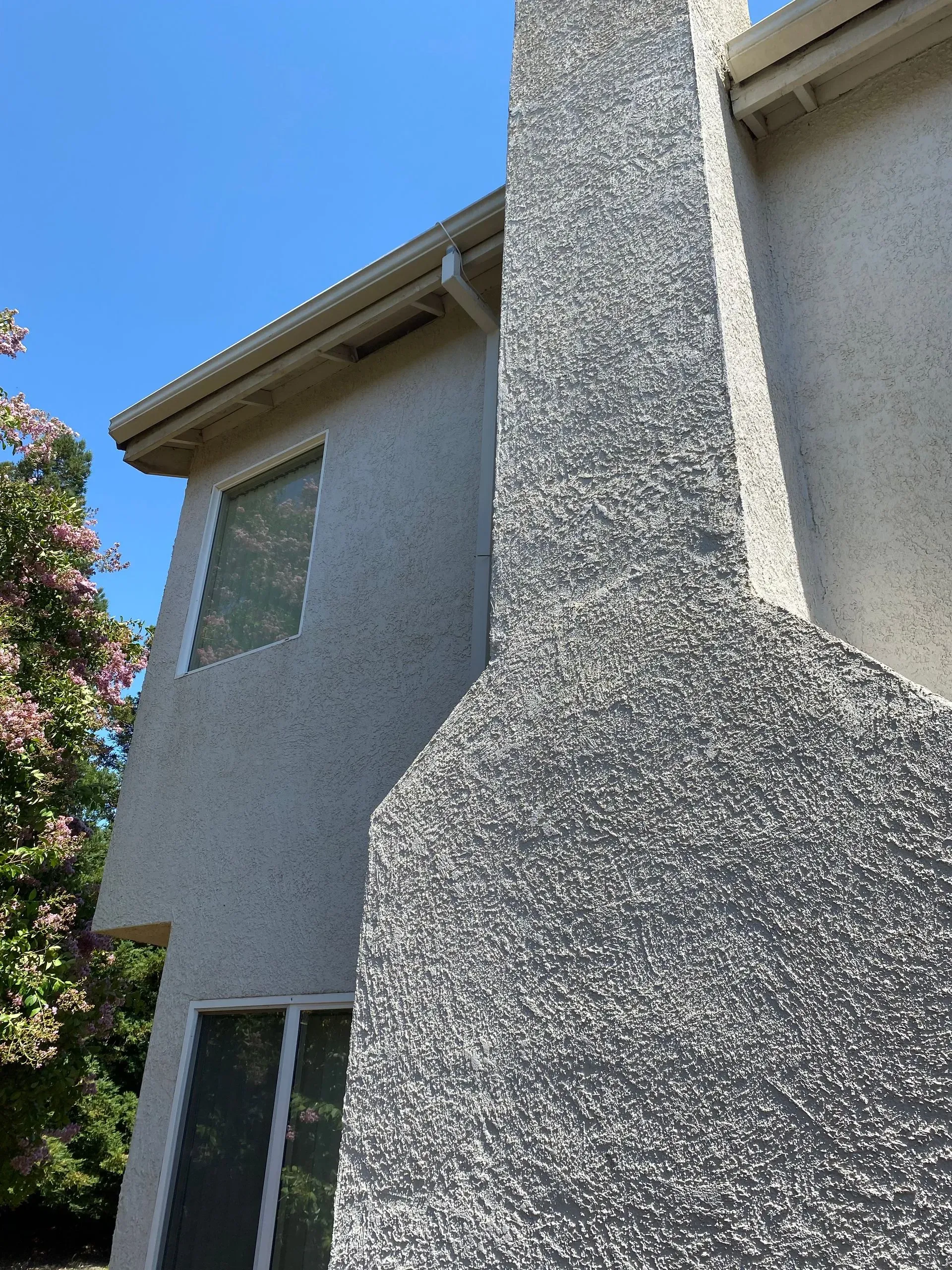 A house with a chimney on the side of it