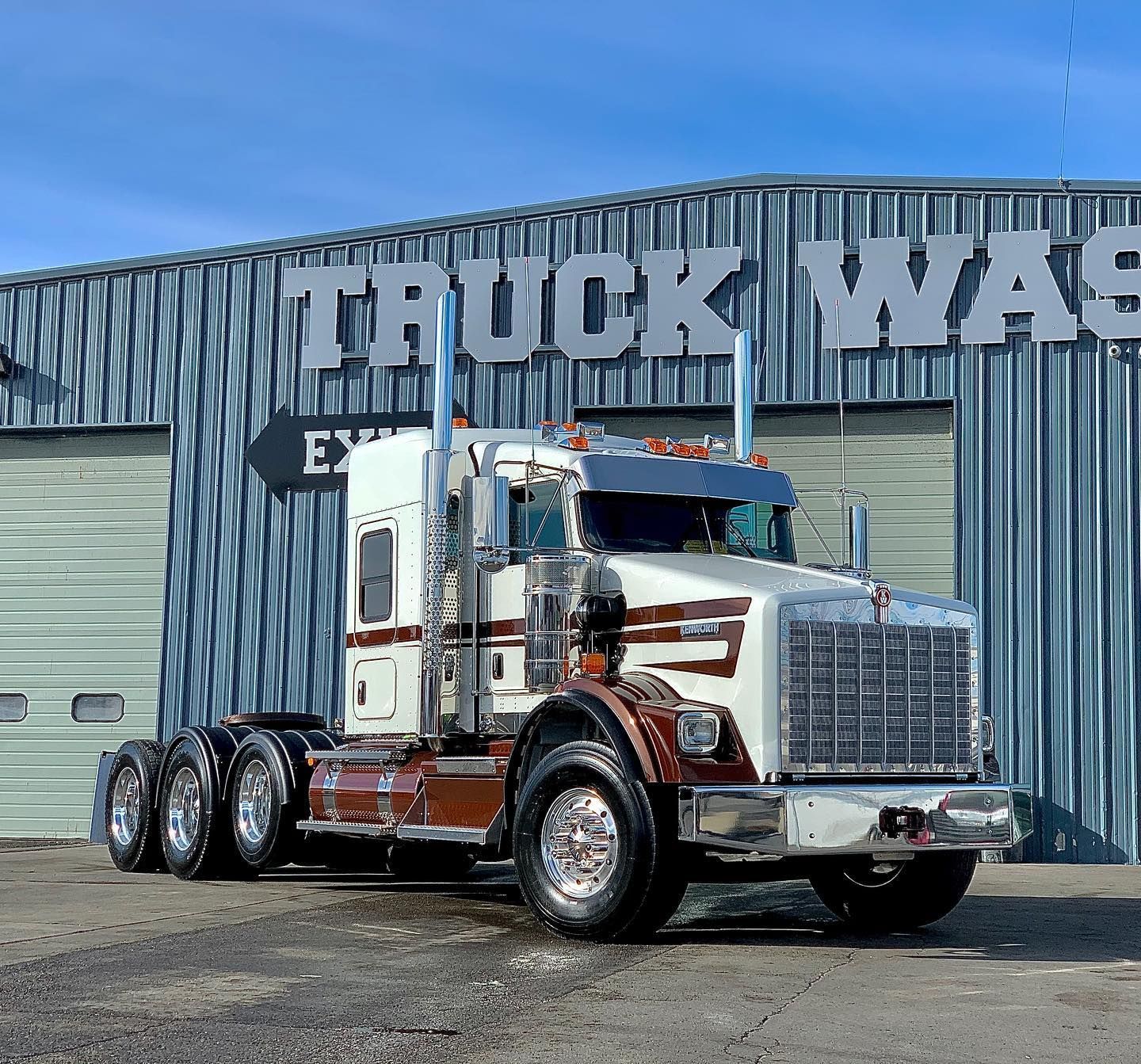 A truck is parked in front of a building that says truck wash