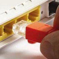 Person plugging in router cable