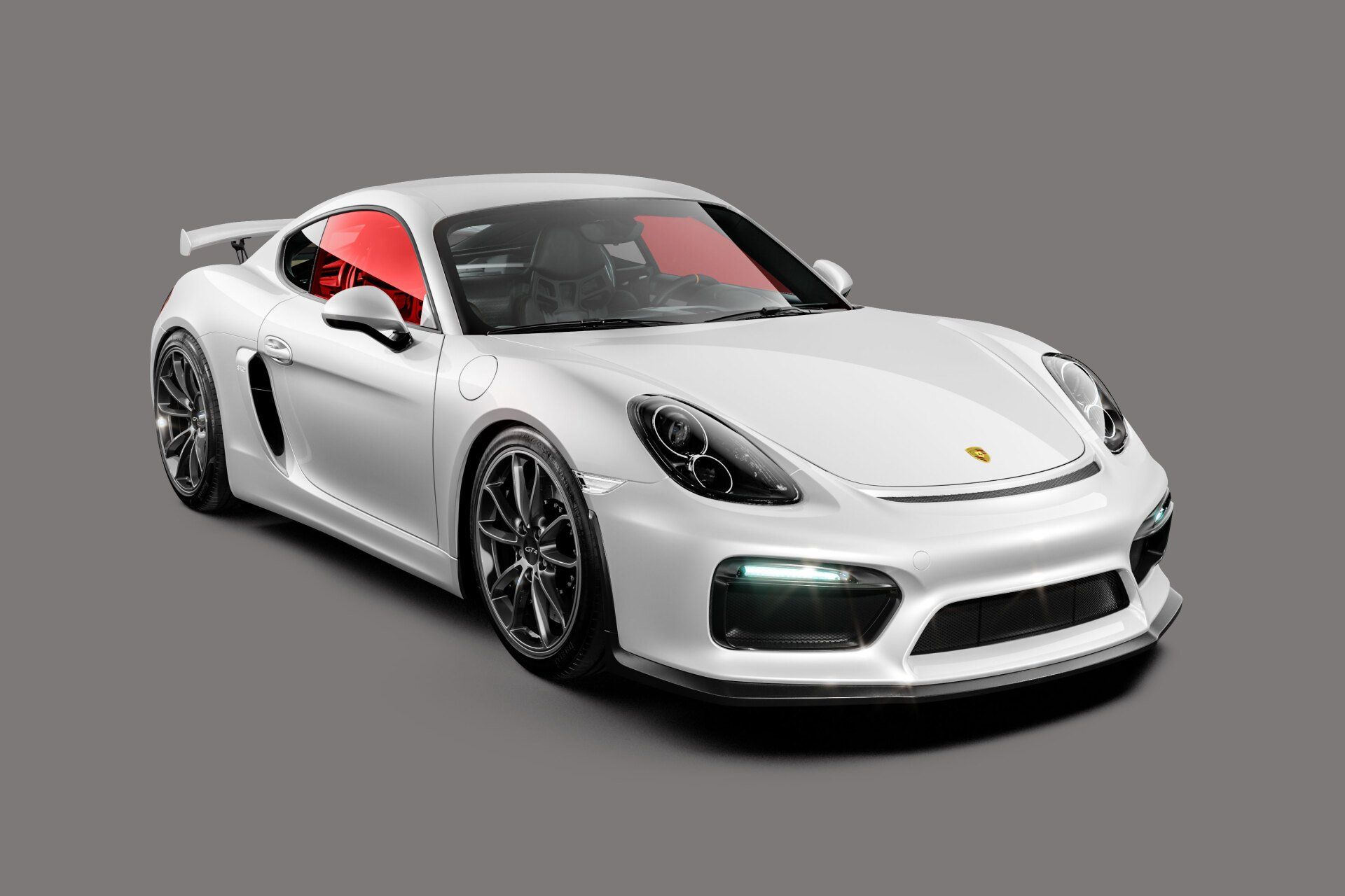White Porsche sports car with red tinted windows, on a gray background.