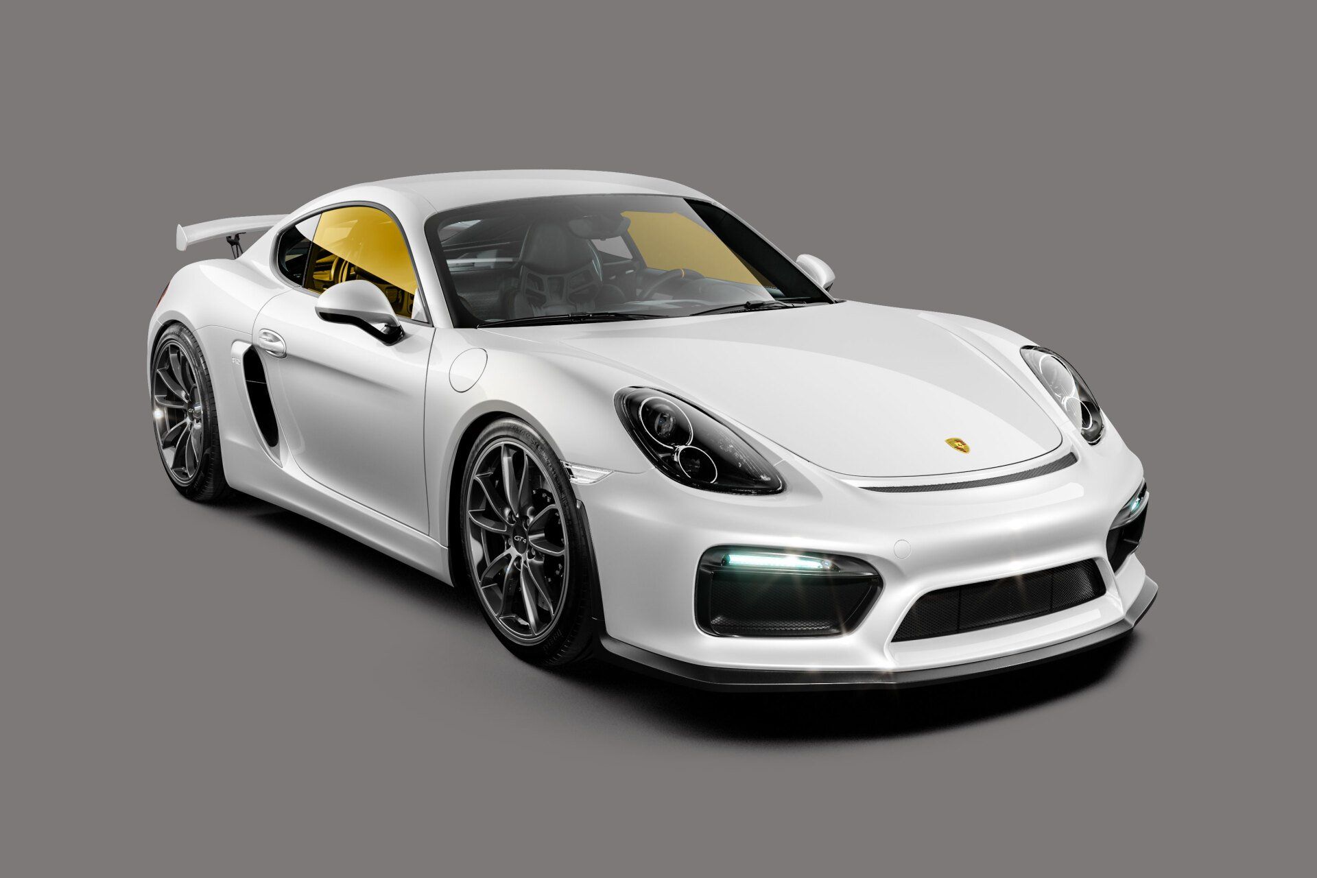White Porsche Cayman sports car on gray background.