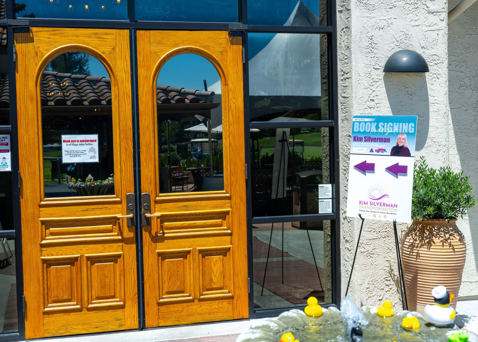 A building with a sign that says book signing kim silverman