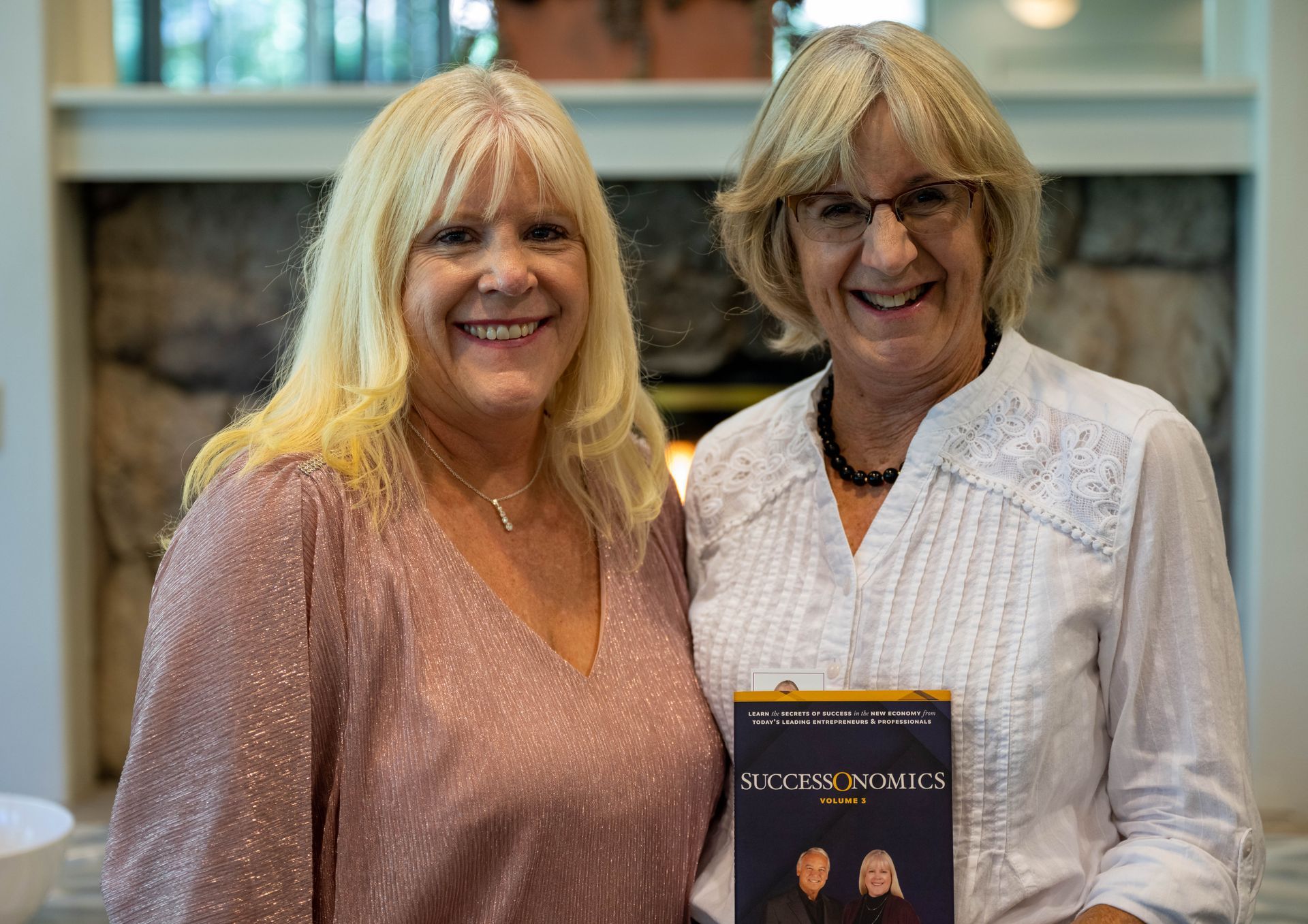 Kim Silverman standing next to a women holding SuccessOnomics book.