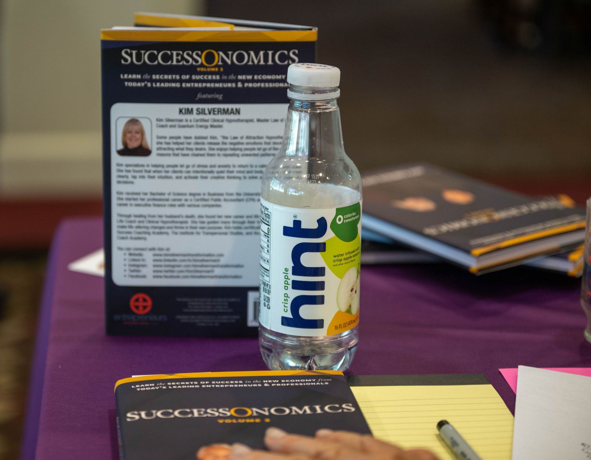 A bottle of hint water sits on a table