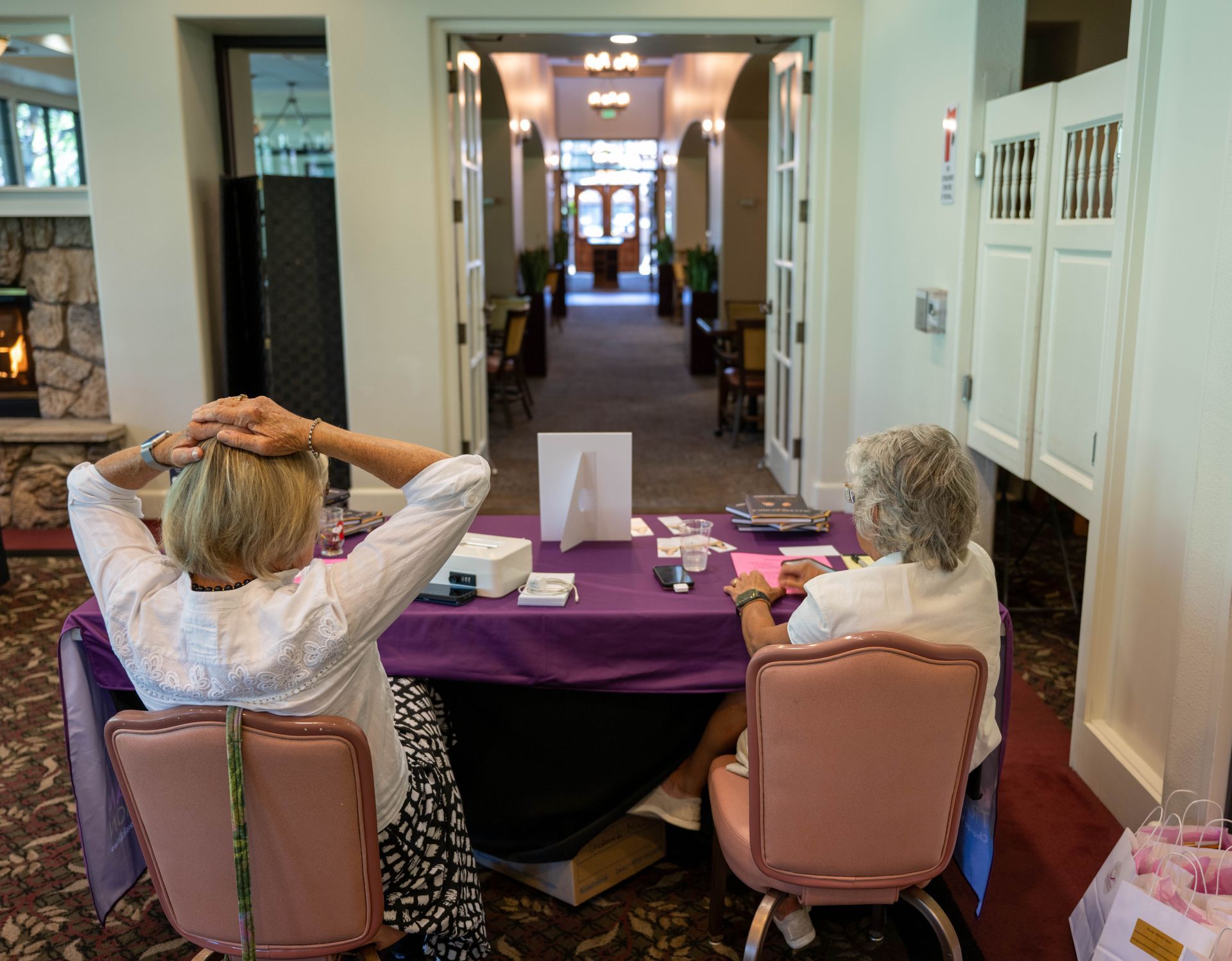 Two women are sitting at a table with their backs to the camera.