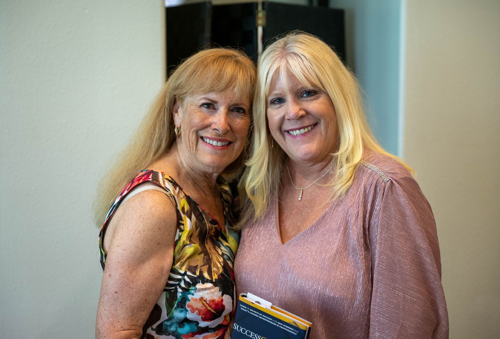 Kim Silverman and a women are posing for a picture together and smiling.