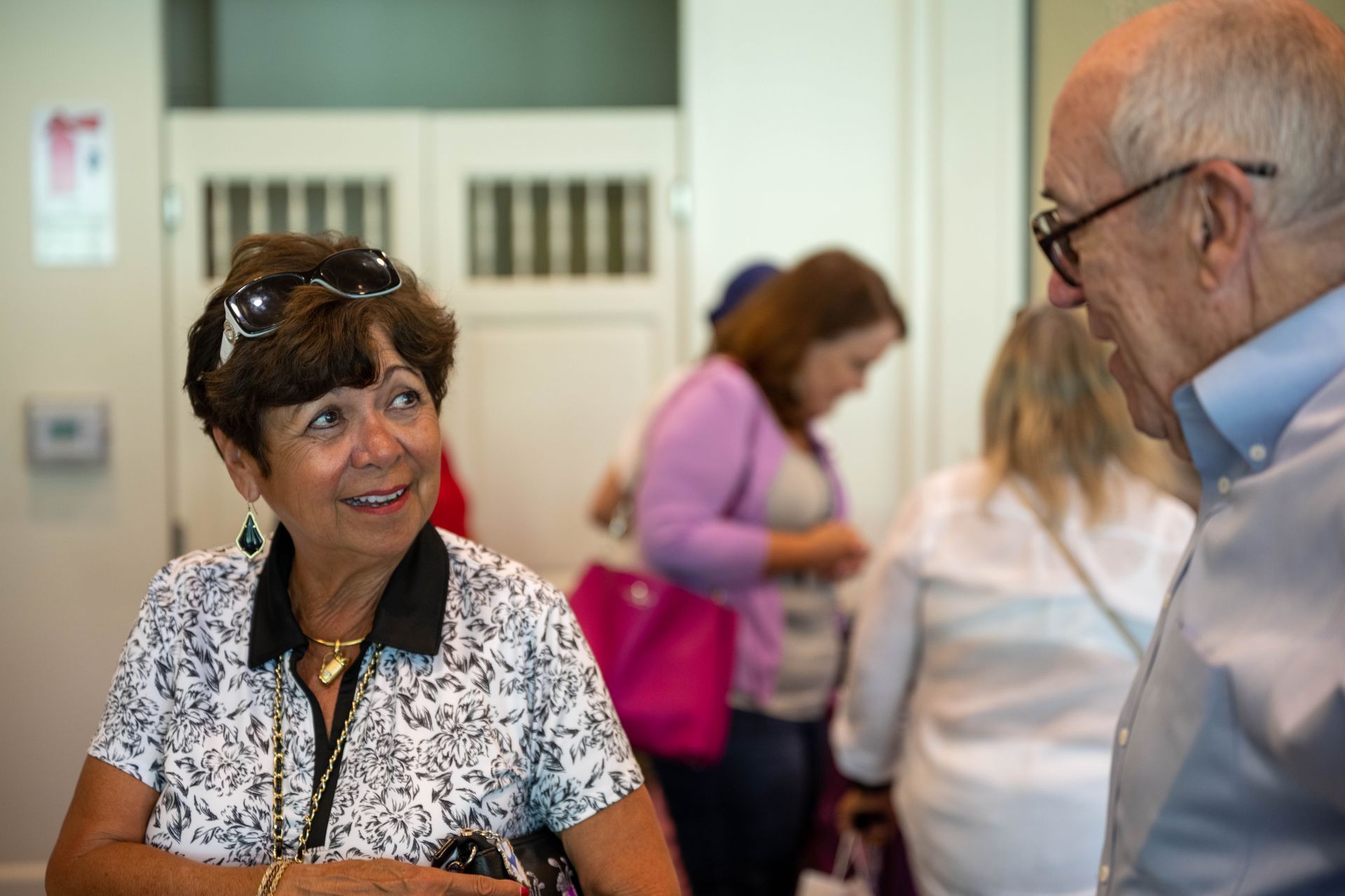 A man and a woman are talking to each other in a room.