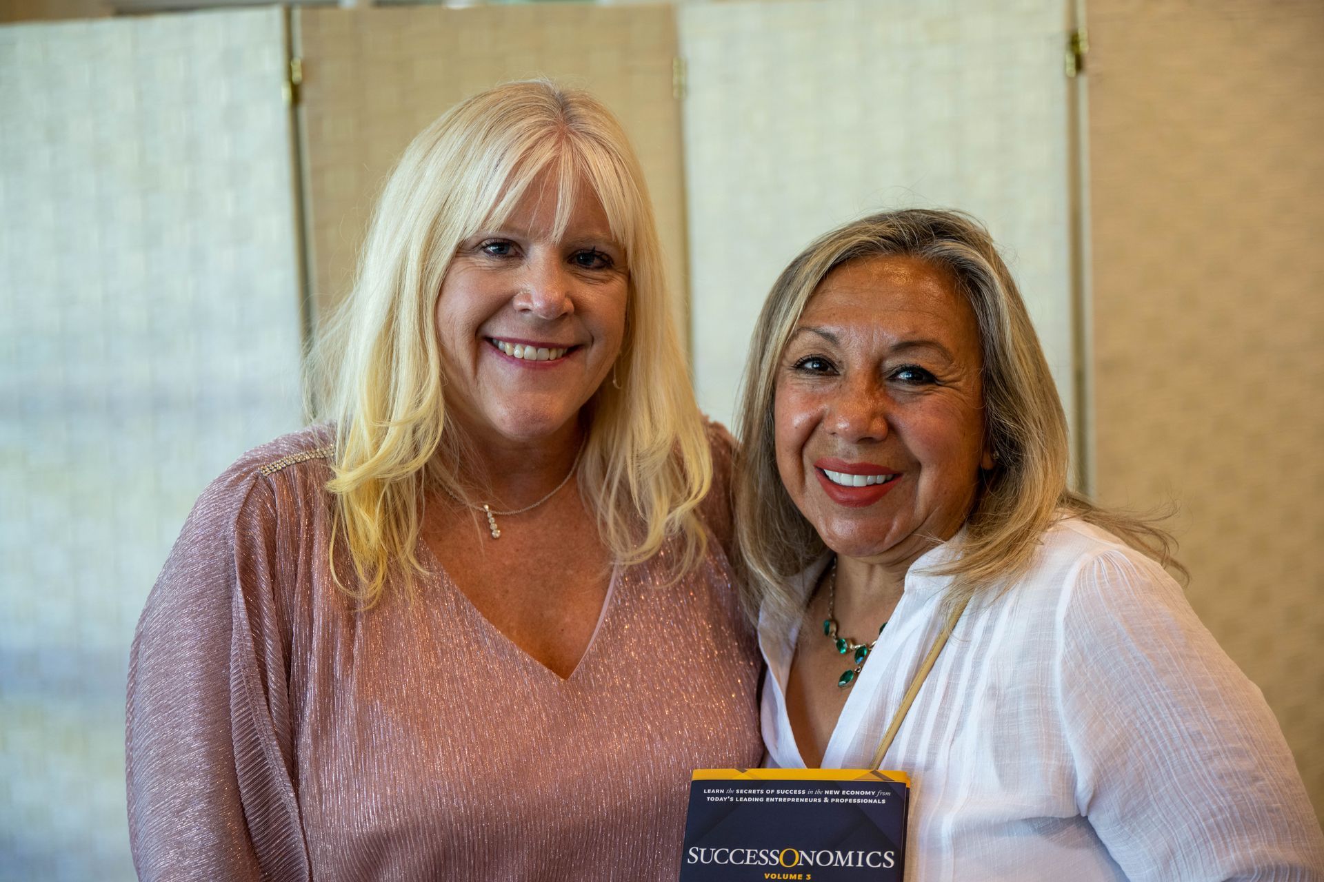 Kim Silverman and a women are posing for a picture together and smiling.