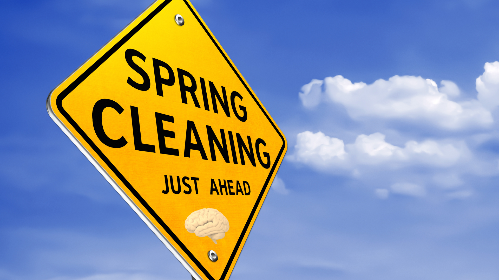 A yellow sign that says spring cleaning just ahead