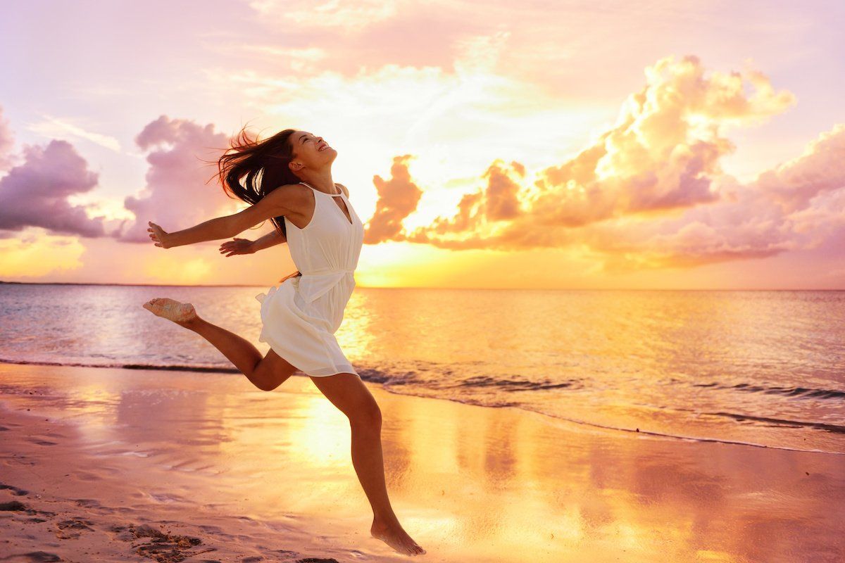 lady running towards the sea on the beach