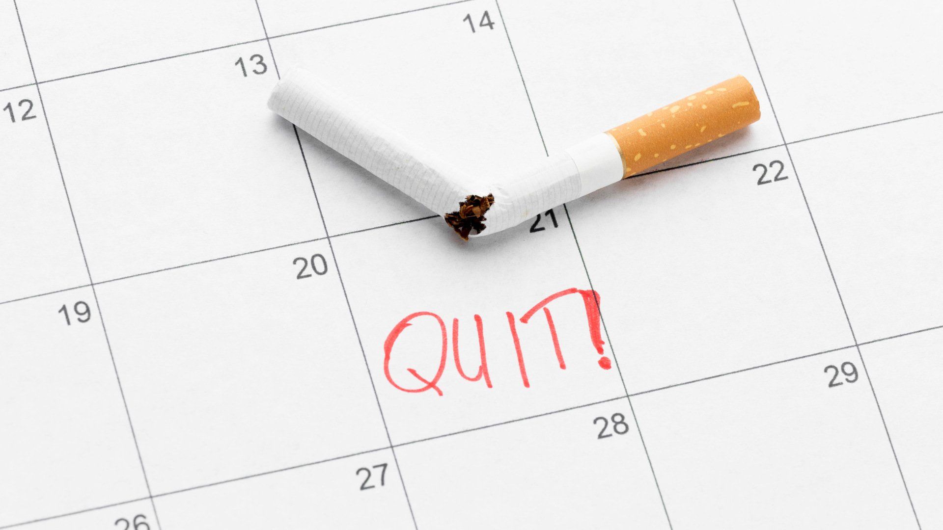 Image of a broken cigarette on a calendar with the word Quit.