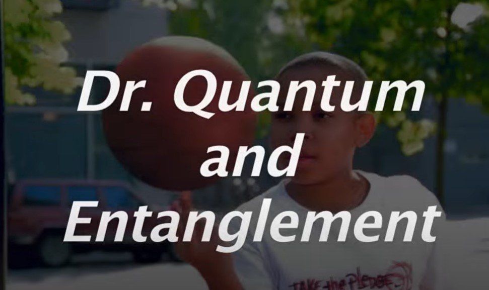A boy is holding a basketball in front of a sign that says dr. quantum and entanglement