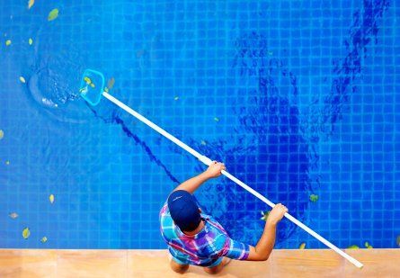 Man on Poolside Cleaning Pool — Poolside Byron Bay in Byron Bay, NSW