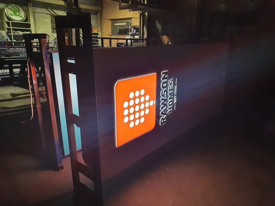 A dark room with a sign that says ' ronson ' on it