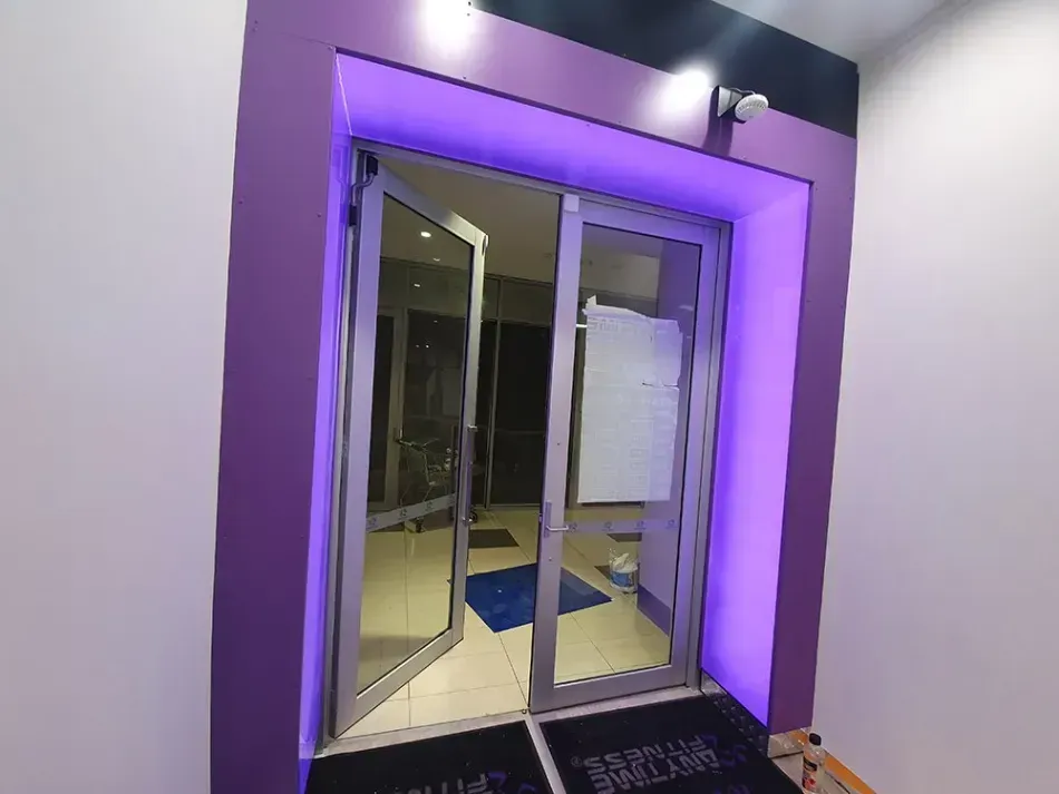 A purple door with a purple light behind it