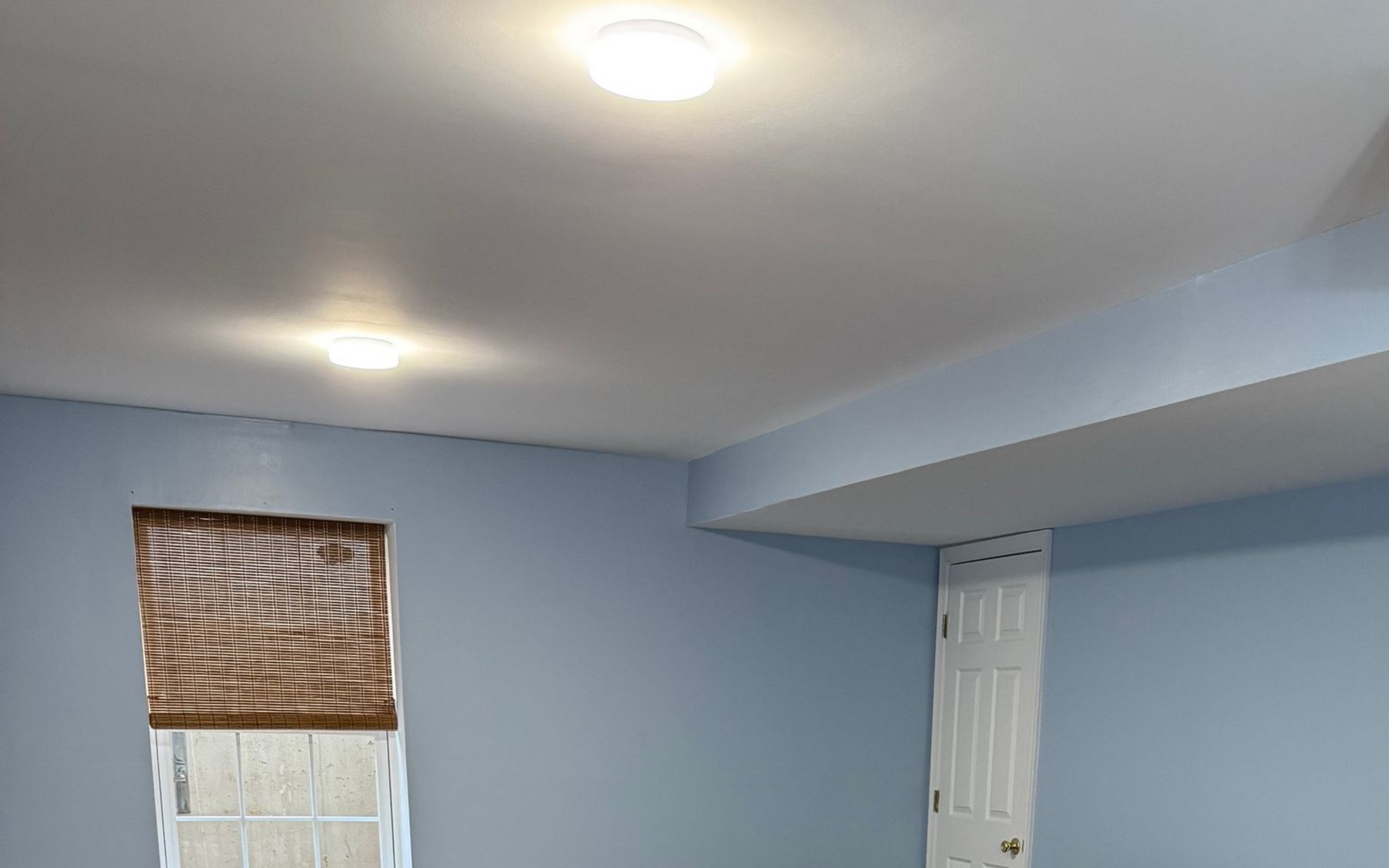 Image of wall and ceiling painting. You can see blue and white. 