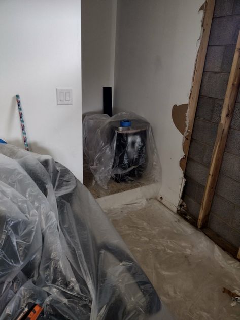 Image of a garage that has broken drywall. 