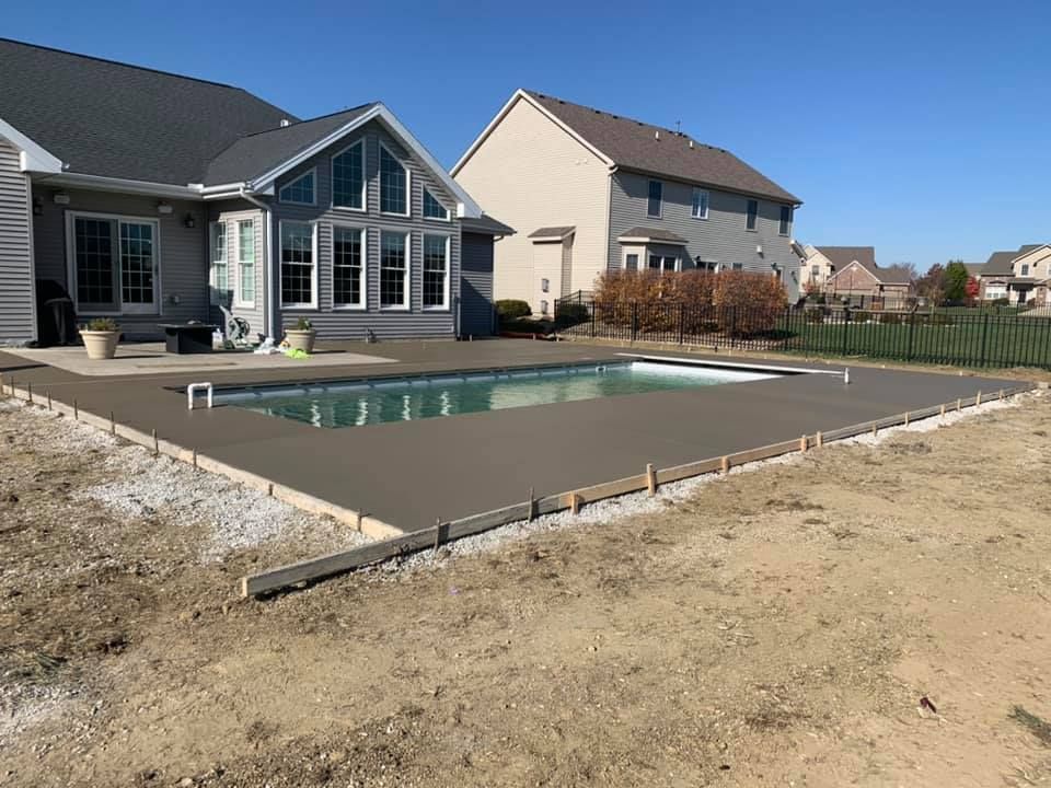 Patio with brick pavers, fire pit, and swimming pool.