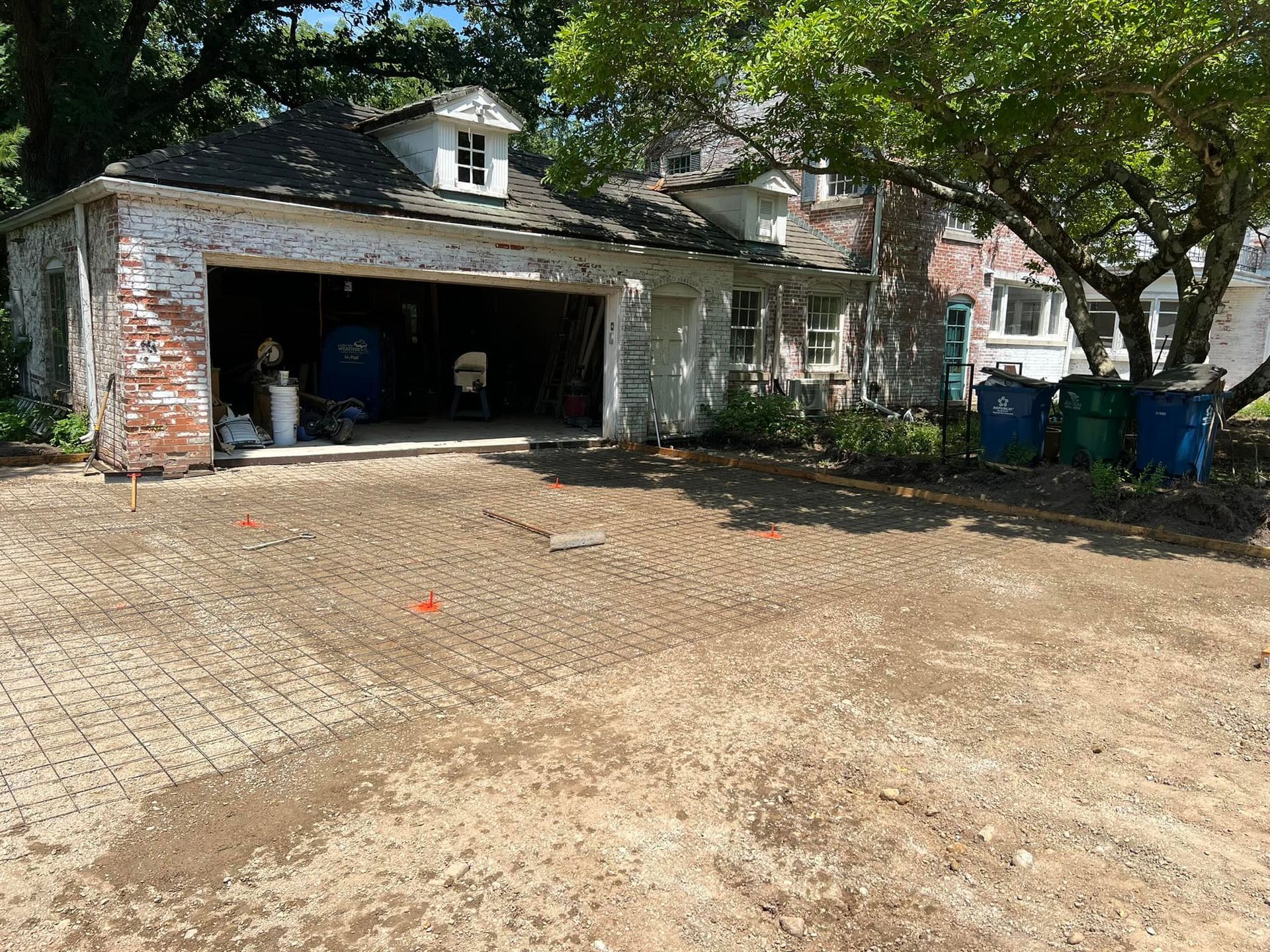 White and black Bobcat skid-steer loader parked outdoors.