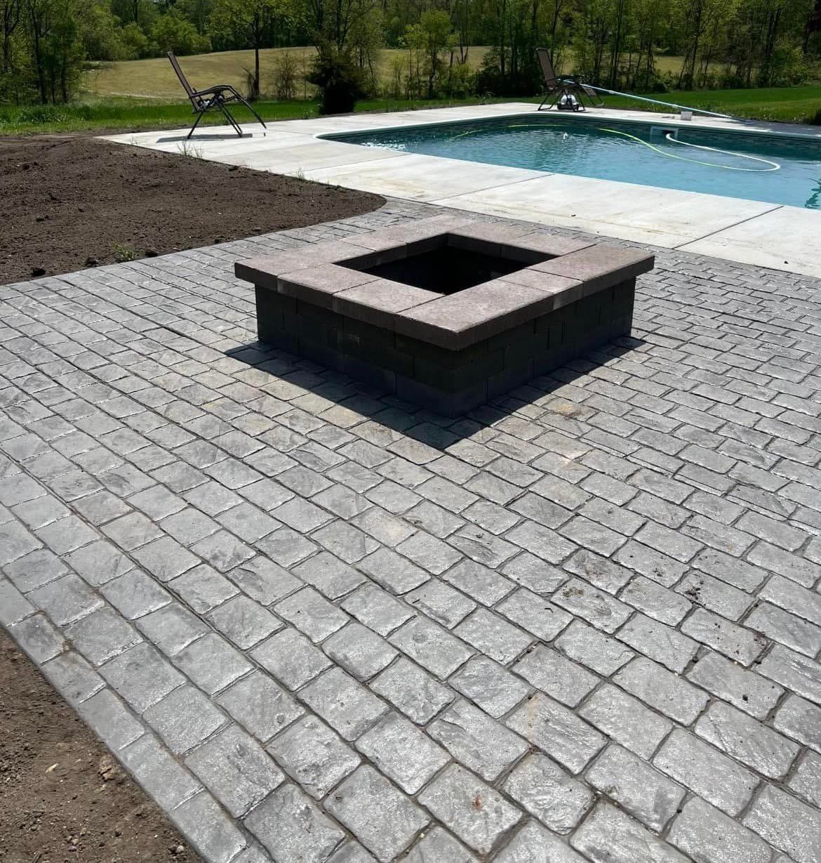 Brown rectangular pavers arranged in a repeating pattern.