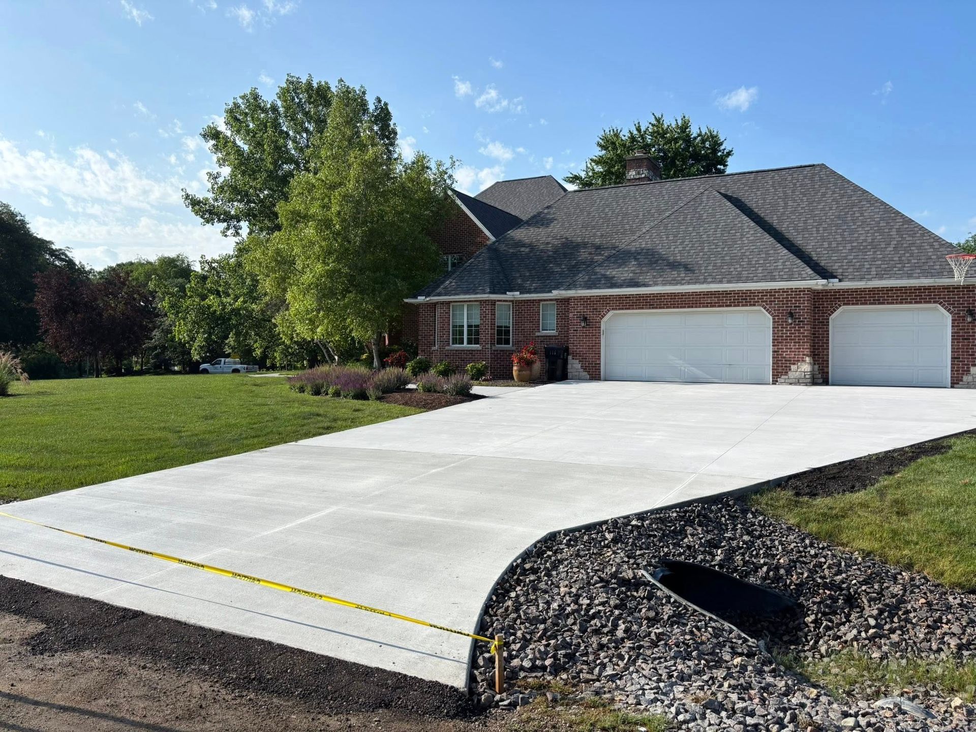 Newly poured concrete pavement sections with visible seams and a wooden border.