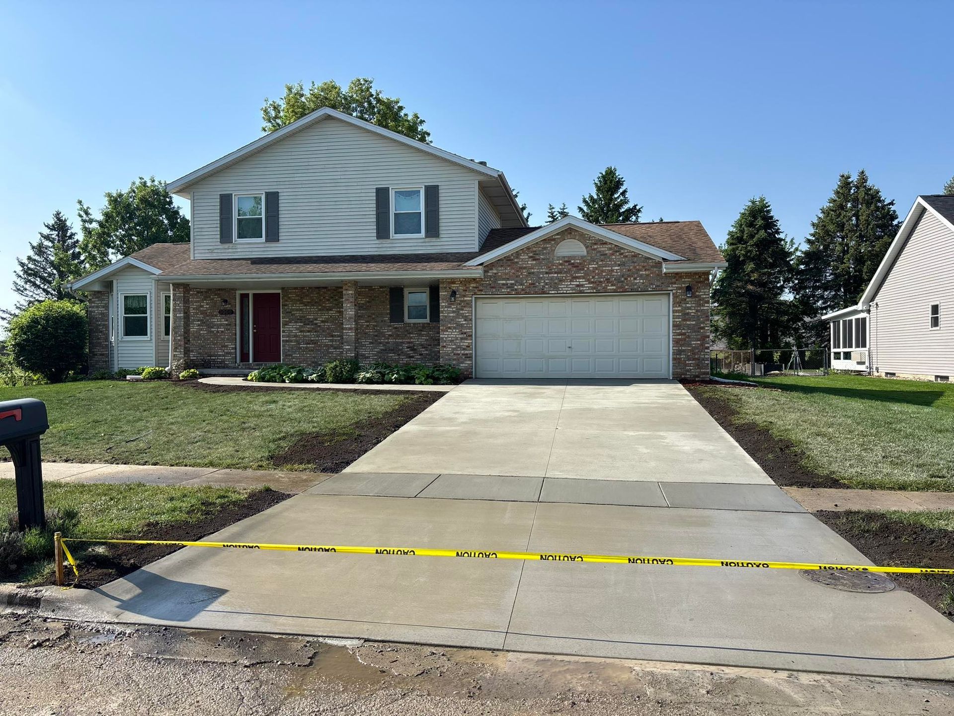 Pergola over patio with table and chairs, stone columns, fire pit, and lawn.