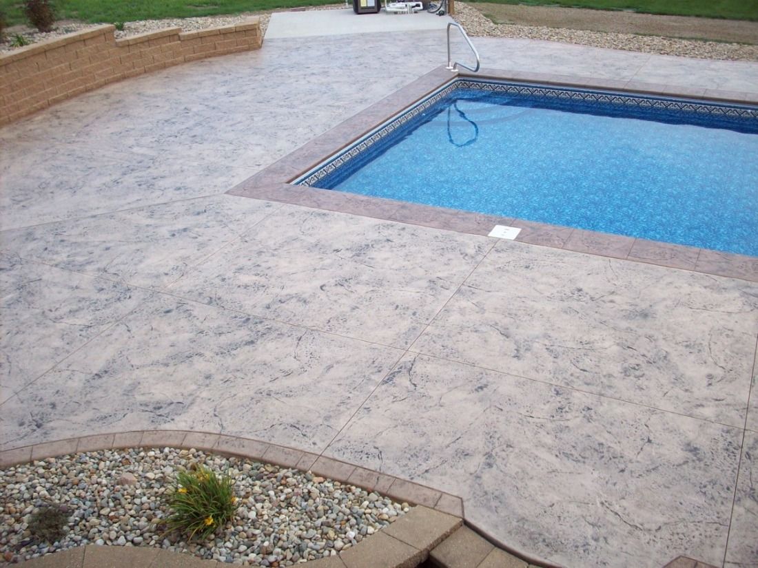 Square brown tiles laid out, with dark, wet patches.