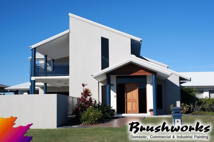 Buckets of Paint, Rollers, Brushes and Gloves on a Stool in a Room With a Yellow Wall — Brushworks Painting In North Albury, NSW.