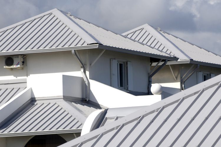 A Group of People Are Painting the Side of a Building — Brushworks Painting In North Albury, NSW.