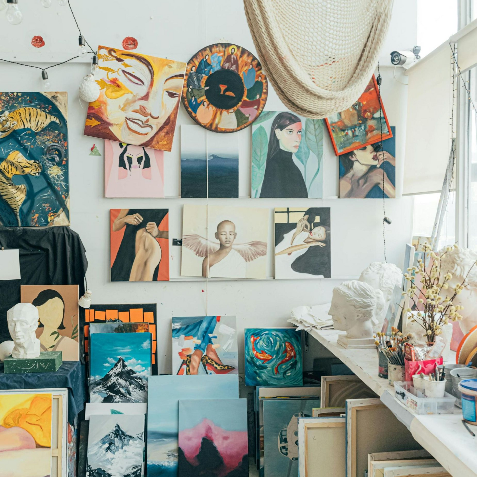 A room with a lot of paintings on the wall