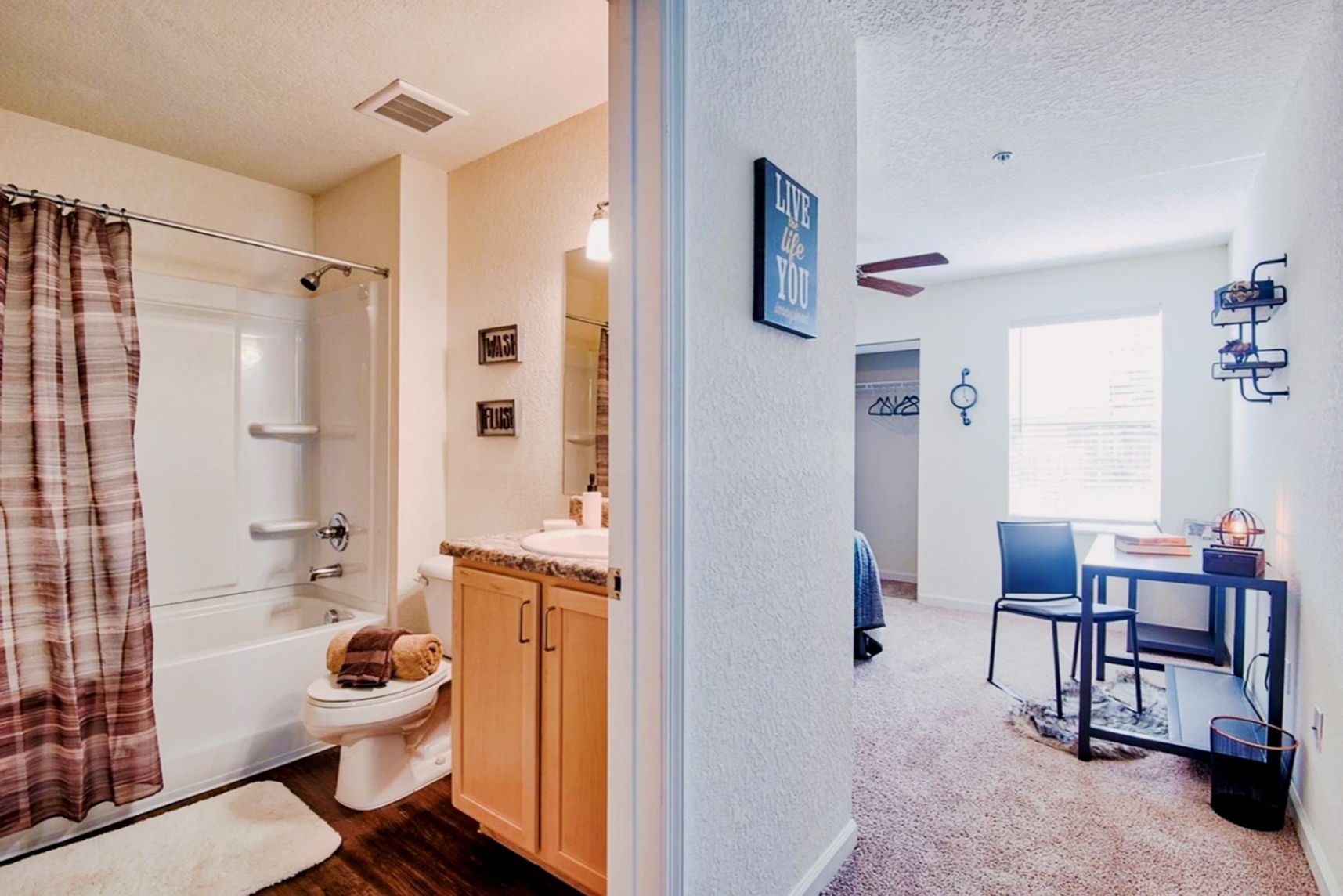 Clean private bathroom with full shower, vanity, and storage at Waypoint at Hammond.