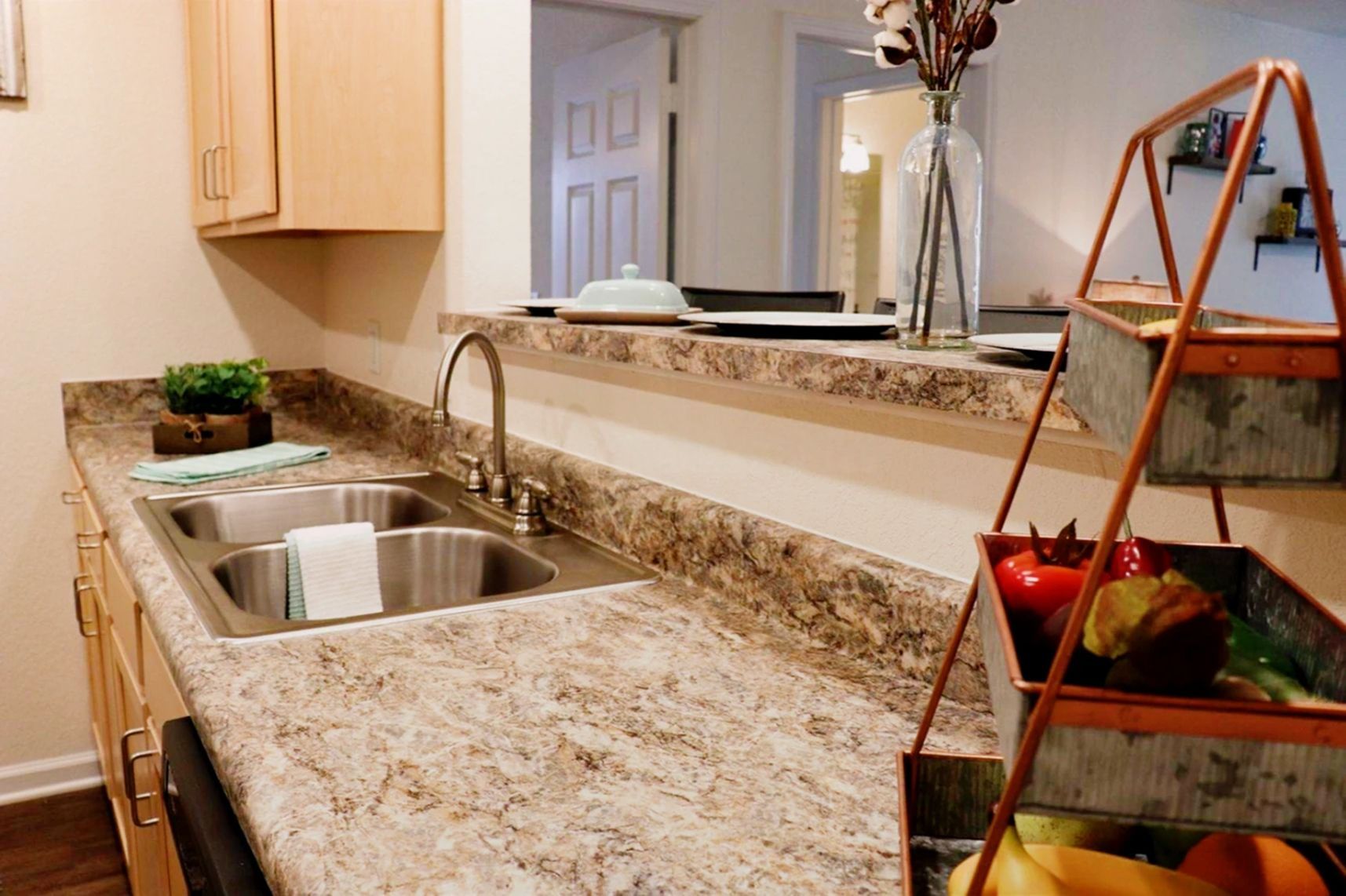 Fully equipped kitchen with countertops, double sink, and modern appliances at Waypoint at Hammond.