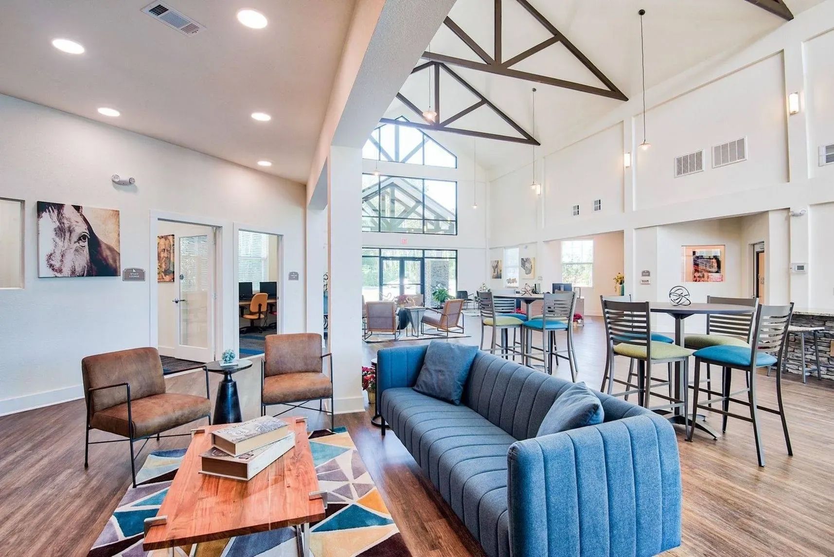 Resident lounge with cozy seating, high ceilings, and community workspace at Waypoint at Hammond.