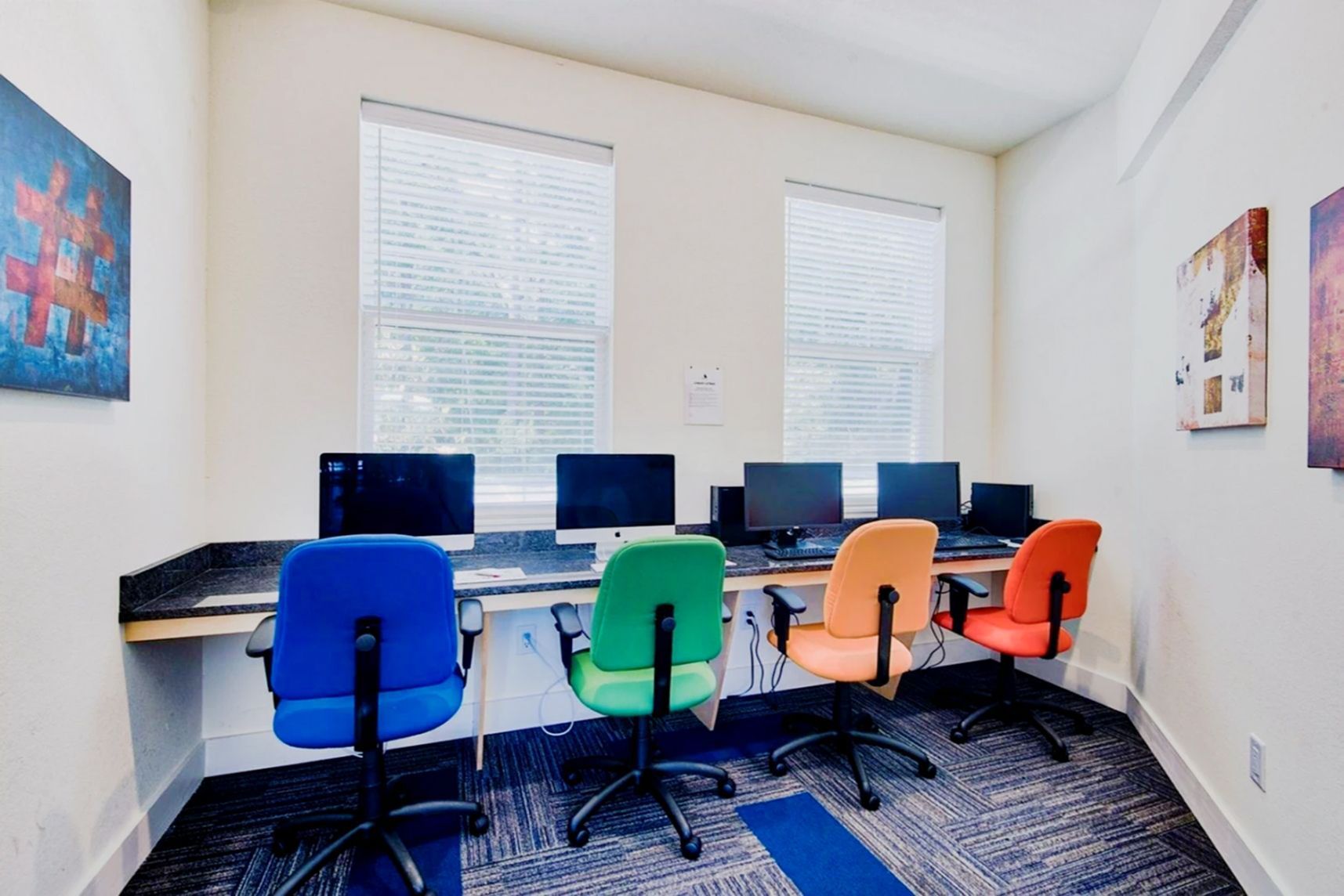 Quiet study lounge with individual desks and colorful chairs for students at Waypoint at Hammond.