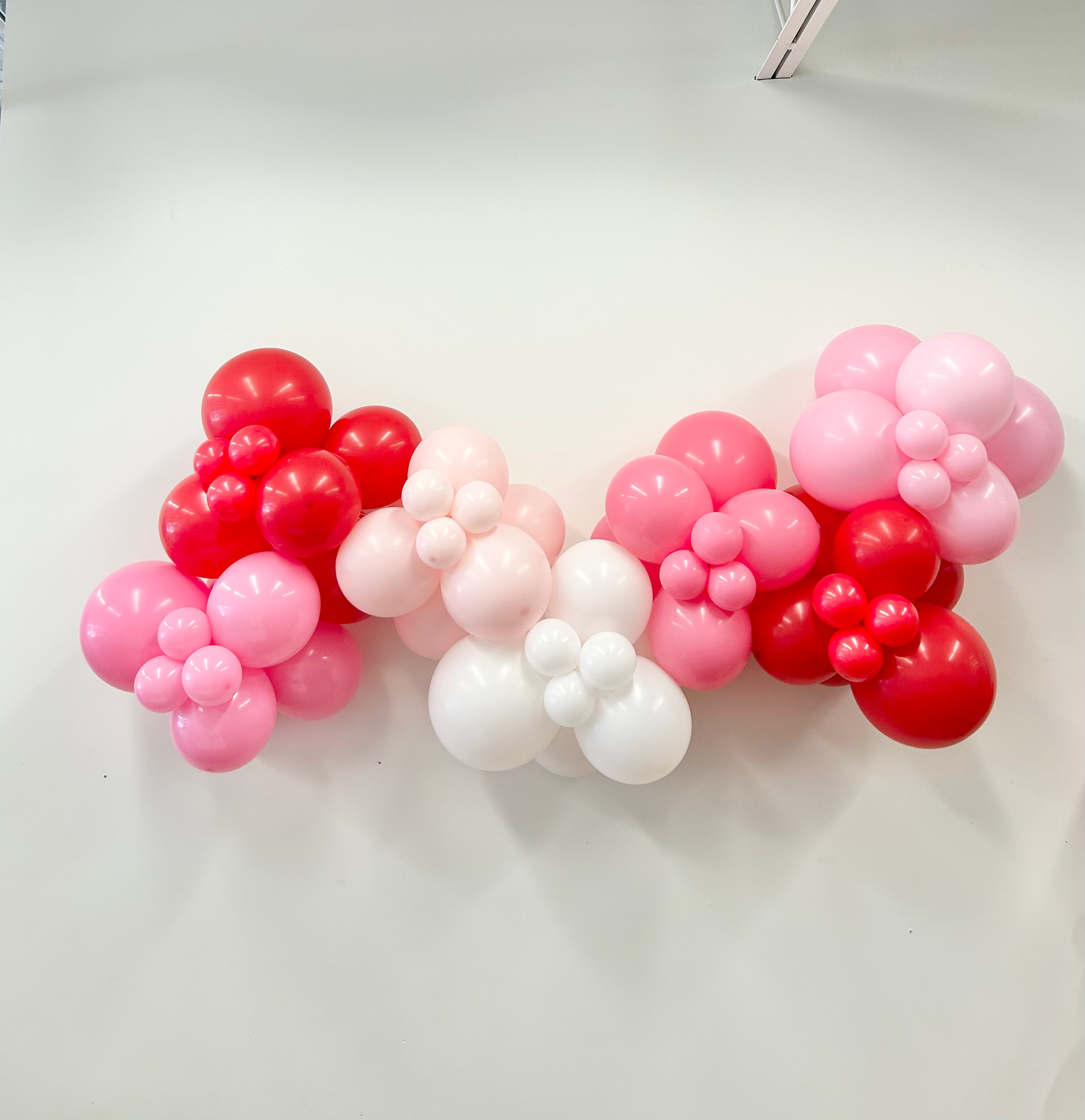 Nicole Boyd with Party Balloon Studio showing a valentines day balloon garland
