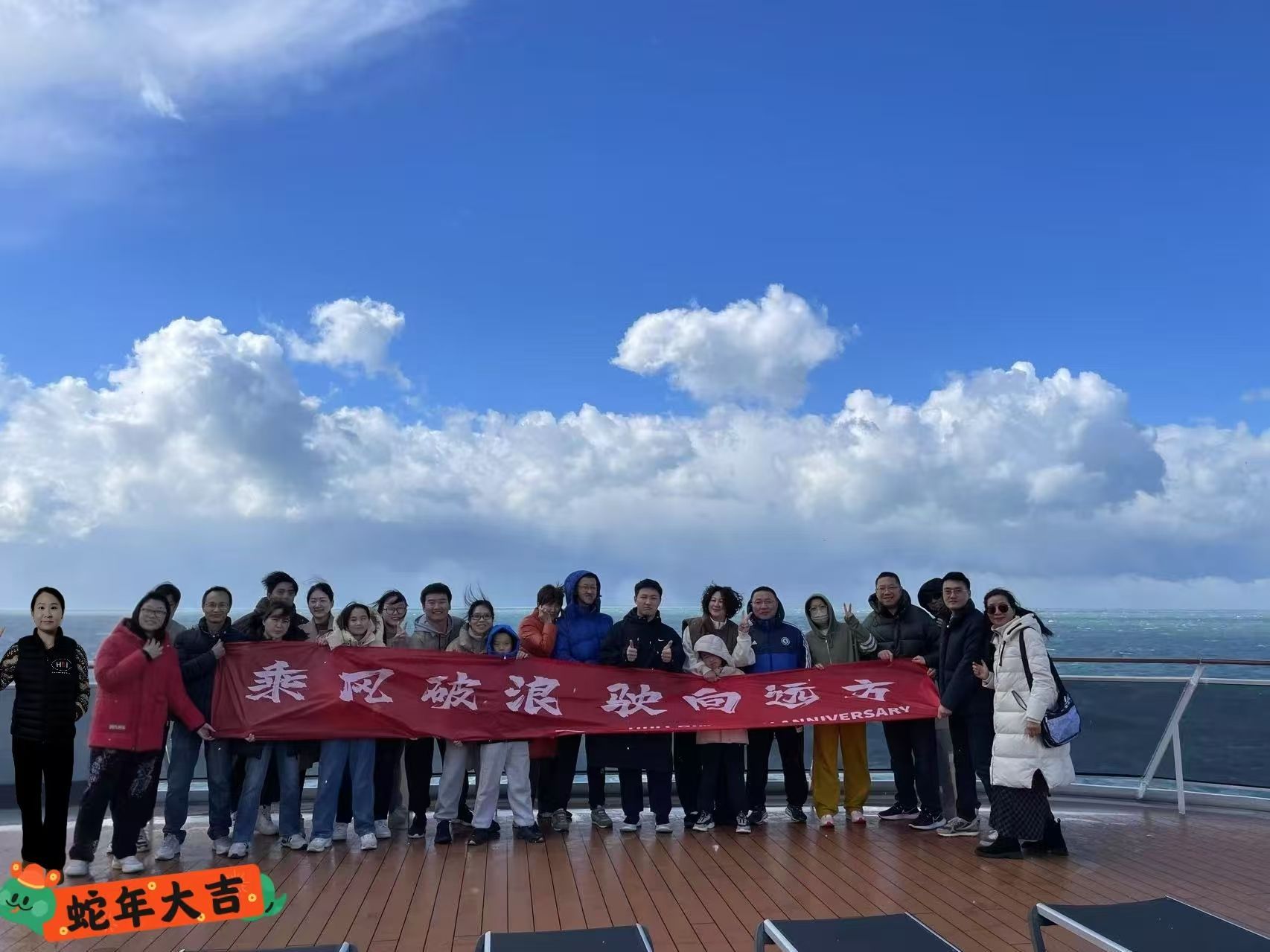 A group of people are posing for a picture on a cruise ship.