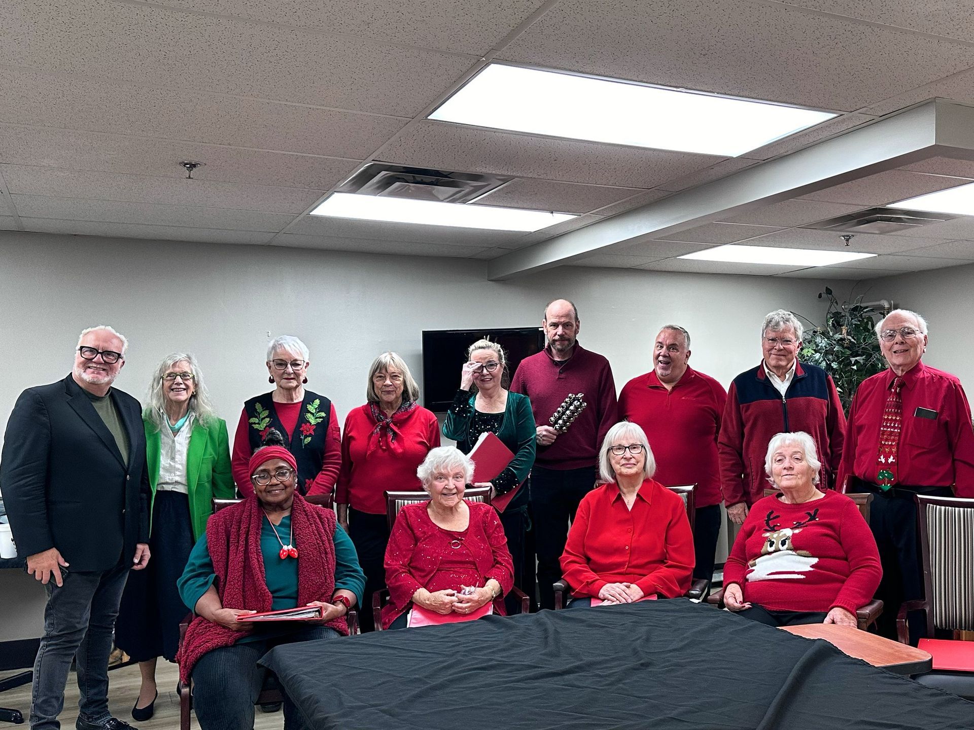 A group of people are posing for a picture in a room.