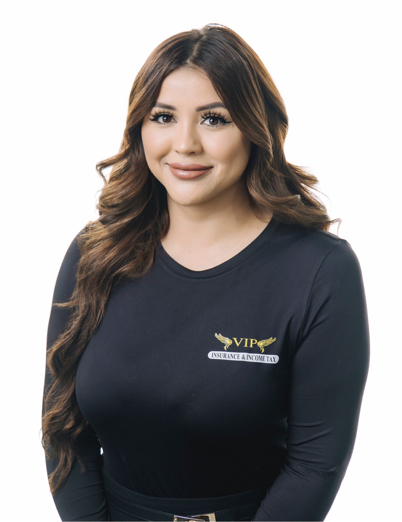A woman with long red hair is smiling in front of a beach background