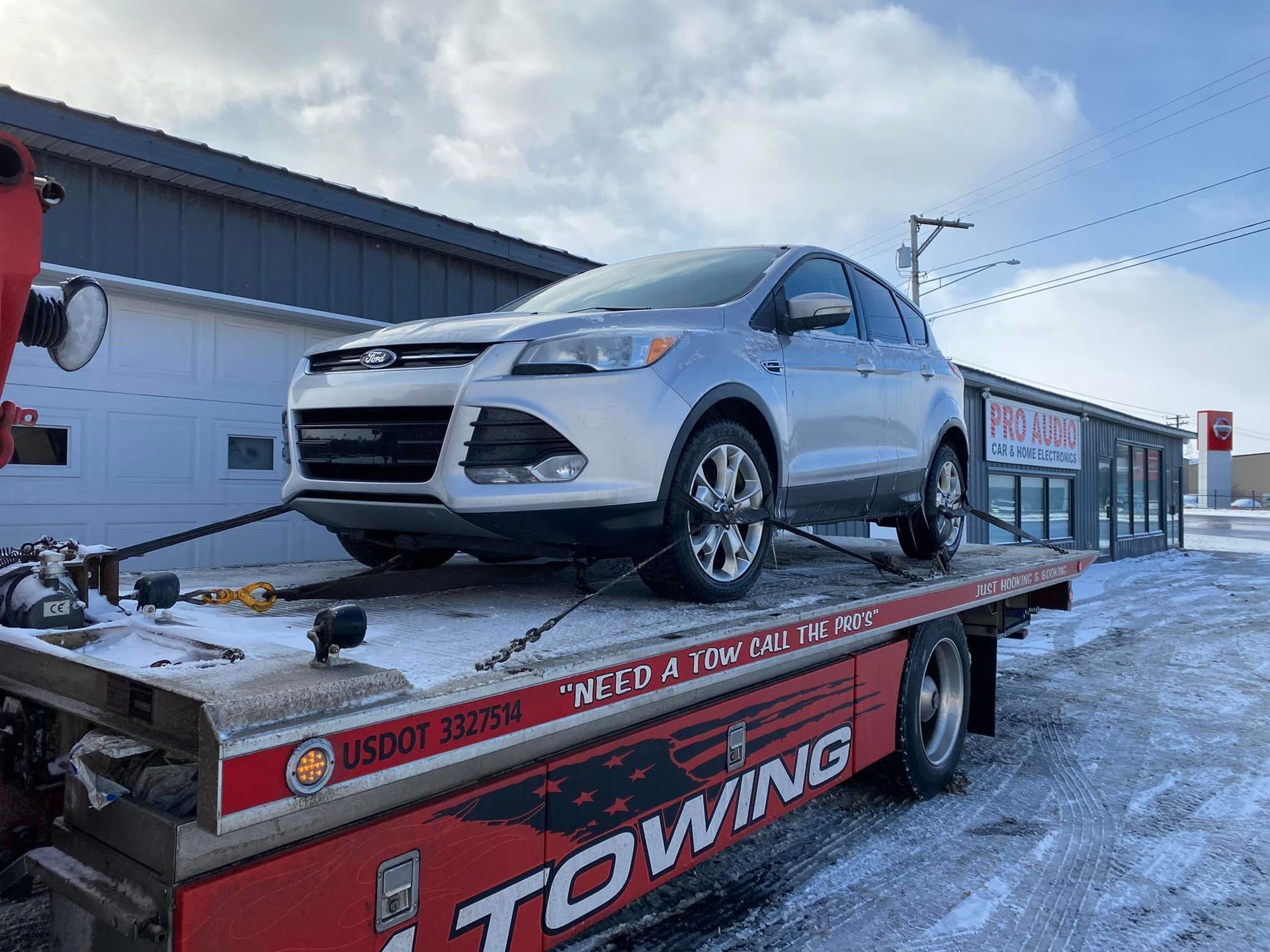 A car is sitting on top of a towing truck.