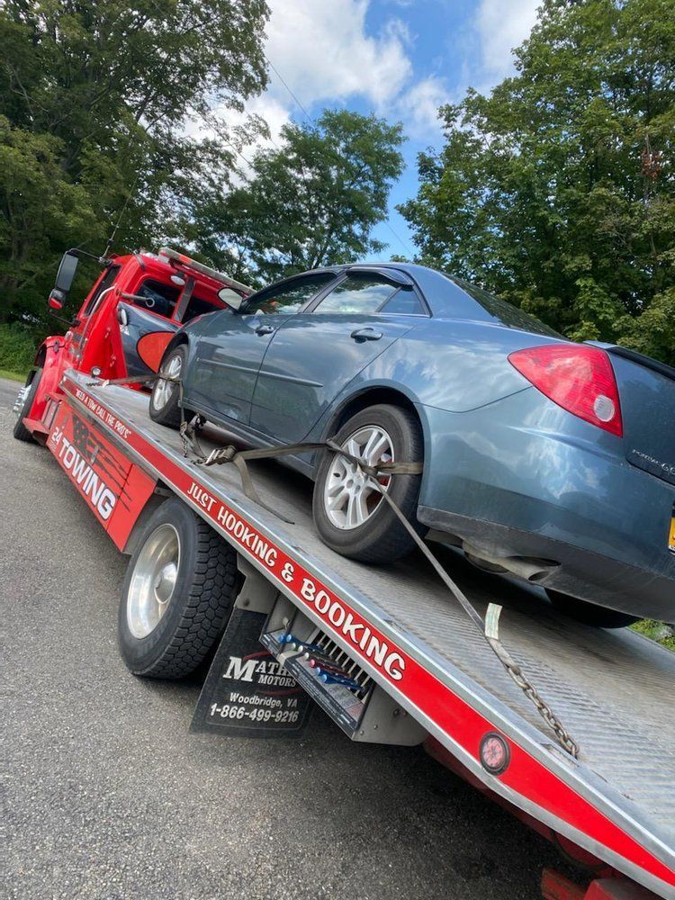 A car is being towed by a tow truck.