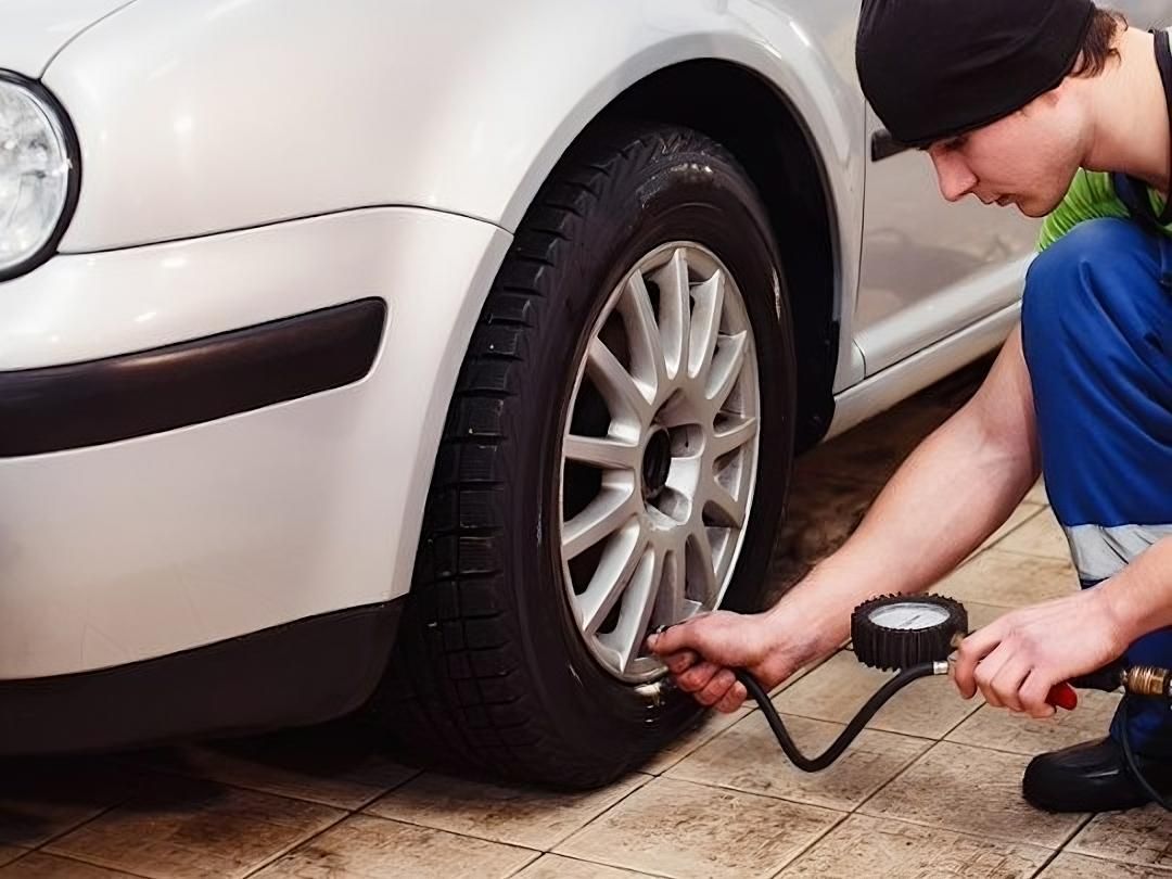A Man is Checking the Tire Pressure — C J Mechanical in Berry, NSW
