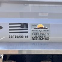 A close up of a sticker on the back of a truck.