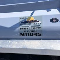 A close up of a sticker on the side of a truck.