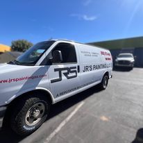 A white van is parked in a parking lot.