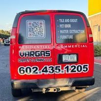 A red van is parked on the side of the road.
