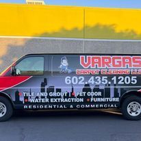 A vargas carpet cleaning van is parked in front of a building.